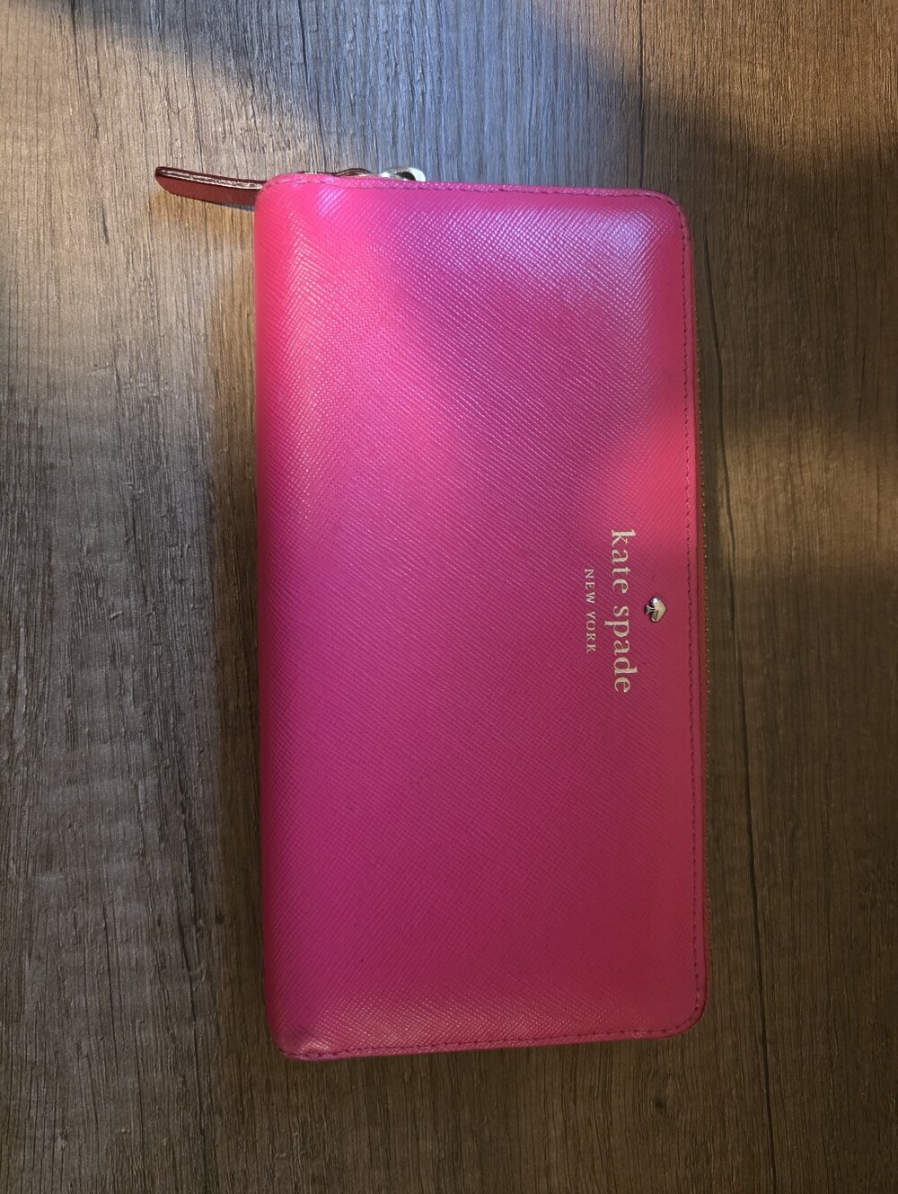 Kate Spade vibrant fuchsia zip-around wallet with gold logo